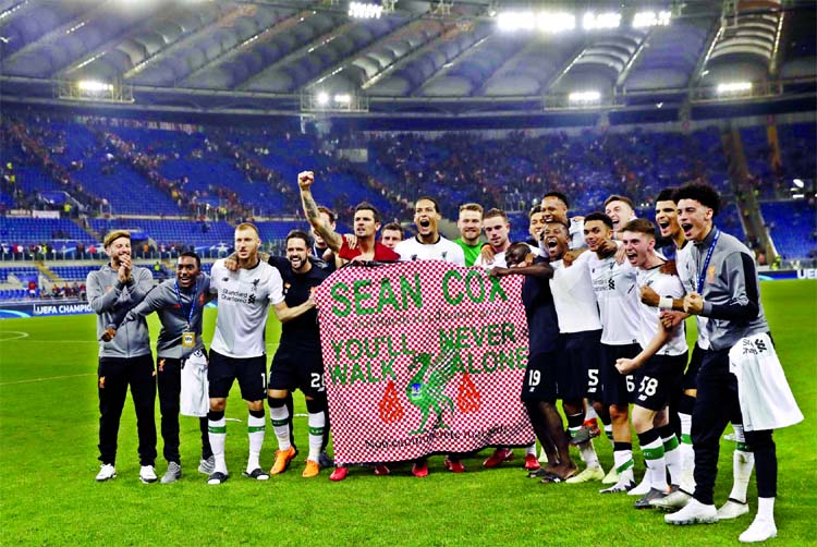 Liverpool players hold a banner in English and Italian in support of Liverpool fan Sean Cox at the end of the Champions League semifinal second leg soccer match between Roma and Liverpool at the Olympic Stadium in Rome on Wednesday. Cox has been in an ind