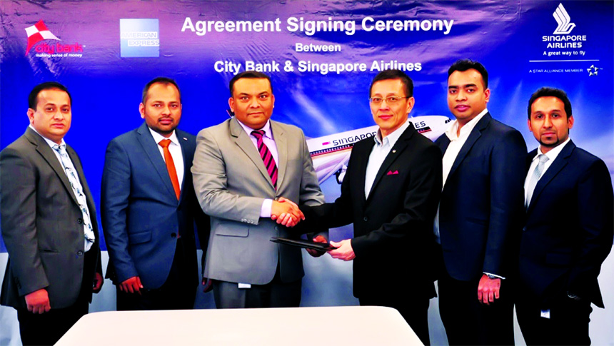 Majharul Islam, Head of Cards of City Bank Limited and TM Wang, General Manager of Singapore Airlines Bangladesh, exchanging an agreement signing documents at the banks head office in the city recently. Under the deal, American Express Credit Card members