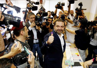 Lebanese Prime Minister and candidate for the parliamentary election Saad al-Hariri shows his ink-stained finger after casting his vote during the parliamentary election in Beirut on Sunday.