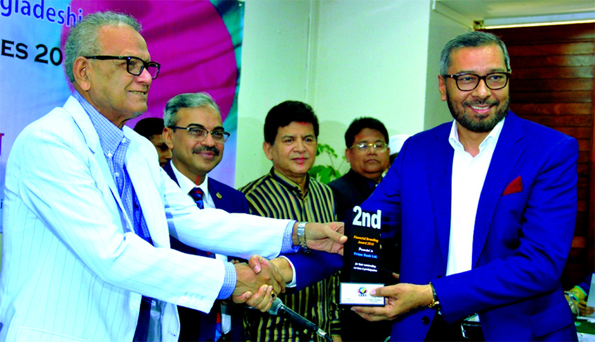 Syed Faridul Islam, Deputy Managing Director of Prime Bank Limited, receiving the 'Financial Branding Award' for its excellent services for the year 2017 from Expatriates' Welfare and Overseas Employment Minister Nurul Islam B Sc a organized by Centre
