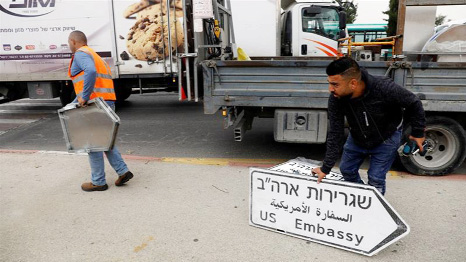 Workers put up road signs directing to the 'US Embassy' in the area of the US consulate in Jerusalem.