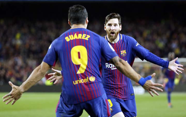 Barcelona's Lionel Messi, rear, celebrates with Barcelona's Luis Suarez after scoring his side's second goal during a Spanish La Liga soccer match between Barcelona and Real Madrid, dubbed 'El Clasico', at the Camp Nou stadium in Barcelona, Spain on