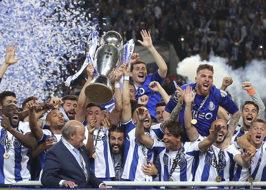 Porto's team captain Hector Herrera lifts the Portuguese league champions trophy after the Portuguese league soccer match between FC Porto and Feirense at the Dragao stadium in Porto, Portugal on Sunday. Porto clinched the league title Saturday night, tw