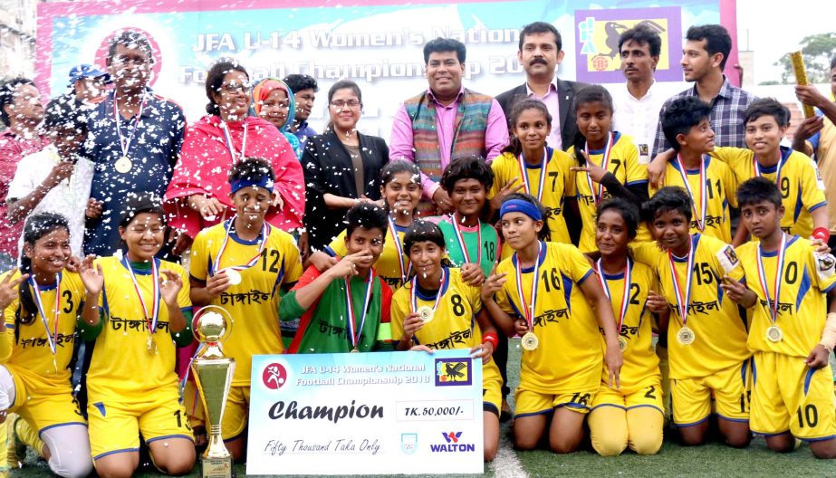 Members of Tangail district women's football team, the champions of the JFA Under-14 National Women's Football Tournament with the guests and officials of Bangladesh Football Federation pose for a photo session at the Bir Shreshtha Shaheed Sepoy Mohamma