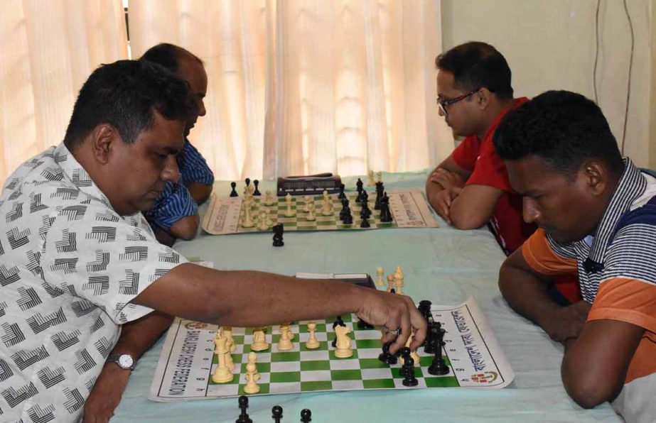 Grand Master Ziaur Rahman (left) moves a pawn against FIDE Master Taibur during their fourth round match of the Rectangle FIDE Rapid Rating Chess Tournament at Bangladesh Chess Federation hall-room on Tuesday.