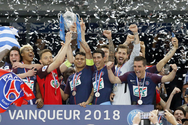 PSG captain Thiago Silva (center right) and Les Herbiers captain Sebastien Flochon (center left) lift the French Cup 2018 trophy with PSG players during the trophy ceremony at the Stade de France stadium in Saint-Denis, outside Paris on Tuesday. Paris Sai