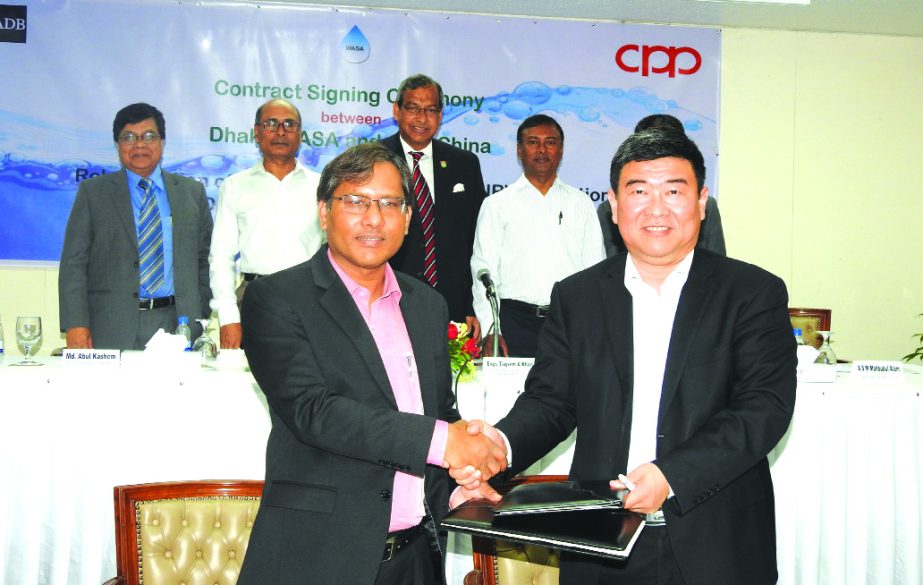 Md Akhtaruzzaman, Project Director of Dhaka Water Supply Network Improvement Project (DWSNIP) and Dong Xue, General Manager of China Petroleum Pipeline Engineering Company Limited (CPP), exchanging a contract signing documents to reduce system loss of wat