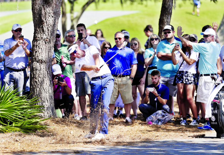 Ian Poulter hits a shot from the rough along the 18th fairway during a practice round at The Players Championship golf tournament in Ponte Vedra Beach, Fla on Wednesday.