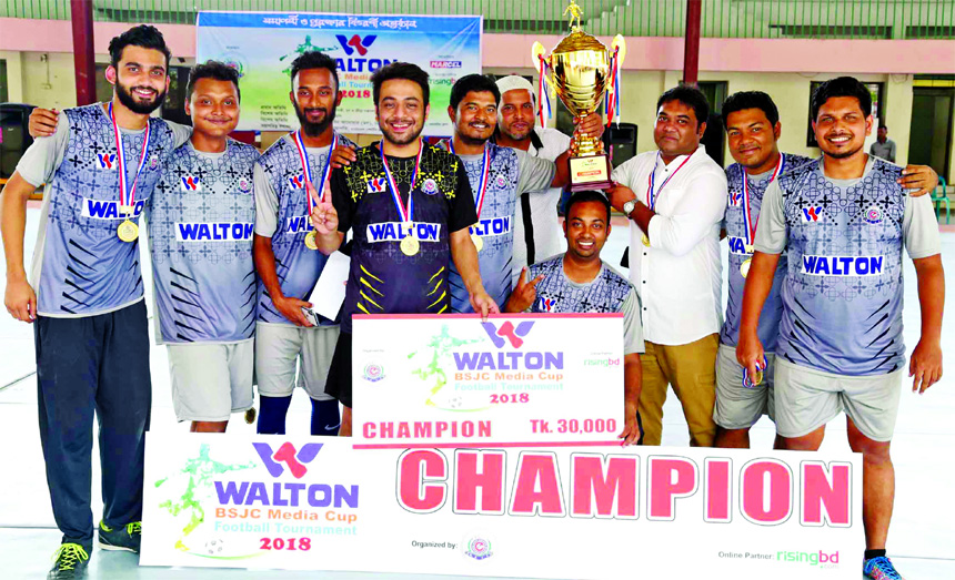 Members of Dhaka Tribune, the champions of the Walton-BSJC Media Cup Football Tournament pose with the trophy at the Shaheed (Captain) M Mansur Ali National Handball Stadium on Saturday.