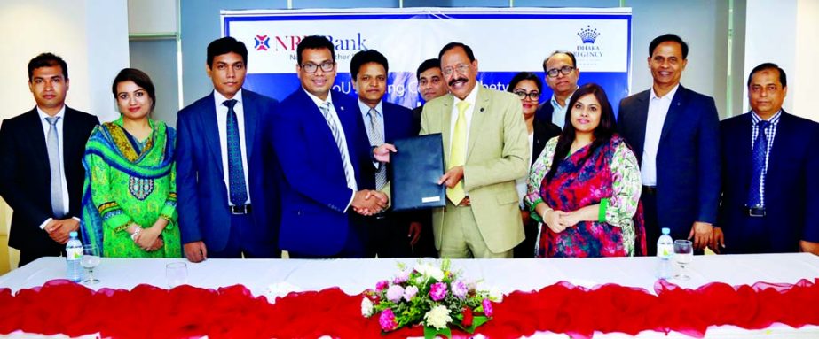 Imran Ahmed, Chief Operating Officer of NRB Bank Limited and Shahid Hamid, Executive Director of Dhaka Regency Hotel and Resort, exchaning an agreement signing documents at the hotel recently. Under the deal, Credit Cardholders of the bank will be privile