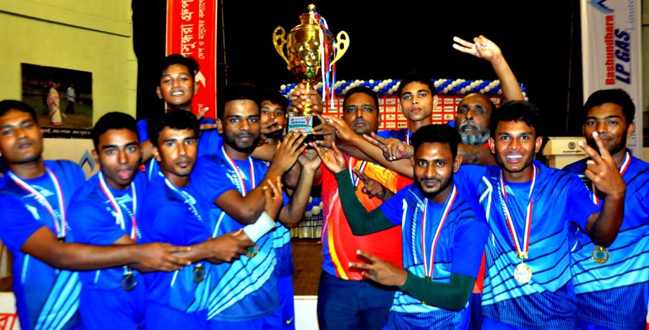 Players of Moulvibazar district Kabaddi team celebrate with the trophy at the Shaheed Tajuddin Ahmed Inddor Stadium on Monday.