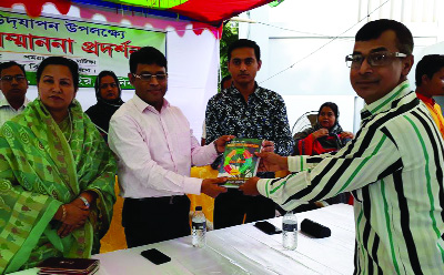 MANIKGANJ: Md Altaf Hossain, Chairman, Manikganj Green Club presenting his book titled 'A Book of Golden Touch Quotations' to Kazi Sahidul Islam, Additional District Judge at a discussion meeting on the occasion of the World Mother's Day on Sunday.