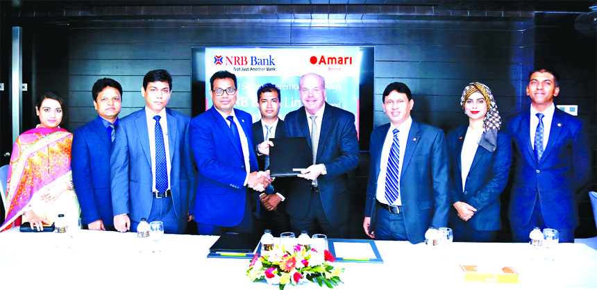 Imran Ahmed FCA, Chief Operating Officer of NRB Bank Limited and Kelly Lewis, General Manager of Amari Dhaka, exchanging an agreement signing documents at the hotel in the city recently. Under the deal, Credit Cardholders of the bank will be privileged wi