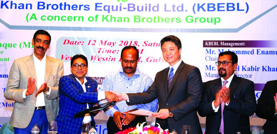 Md Enamul Kabir Khan, Chairman of Khan Brothers Equi-Build Ltd, a sister concern of Khan Brothers Group and Roger S Che, Director (Asia Region) of SIGMA Elevator Distributorship sign a MoU at a city hotel recently. State Minister for Labour & Manpower Em