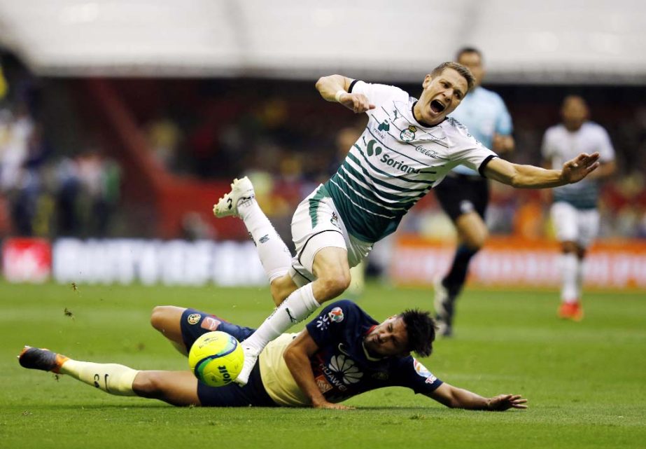 Santos' Julio Furch (top) collides with America's Bruno Valdez in their Mexican soccer league second-leg semifinal match, at Azteca Stadium in Mexico City on Sunday. The game ended 2-2 and Santos will face Toluca in the league finals.