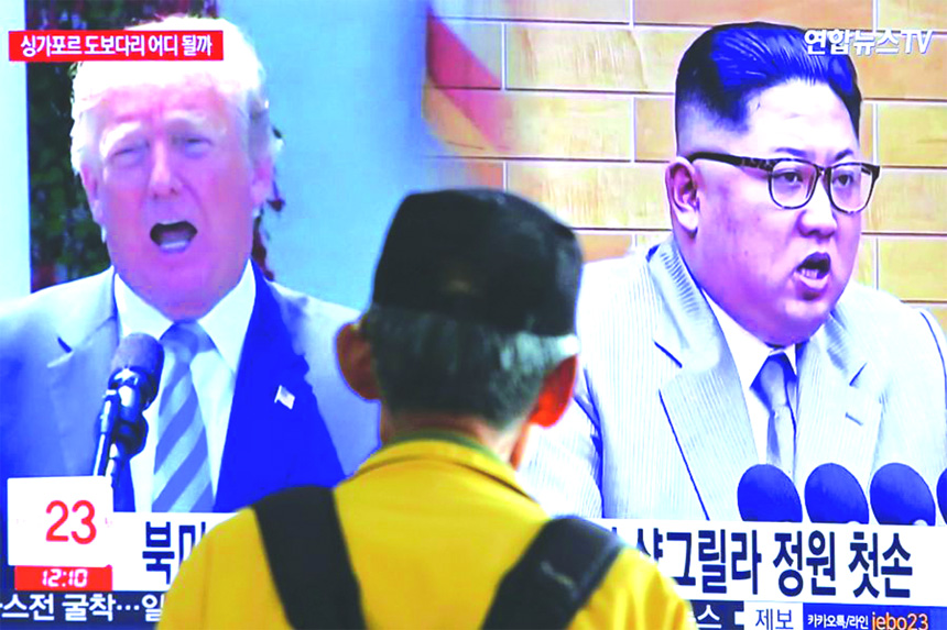 A man watches a TV screen showing file footage of U.S. President Donald Trump, right, and North Korean leader Kim Jong Un during a news programme at the Seoul Railway Station in Seoul, South Korea, on Wednesday on Wednesday.