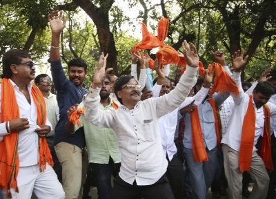 Bharatiya Janata Party (BJP) supporters dance to celebrate after their leader B. S. Yeddyurappa was sworn in as Chief Minister of Karnataka state in Bangalore, India, on Thursday