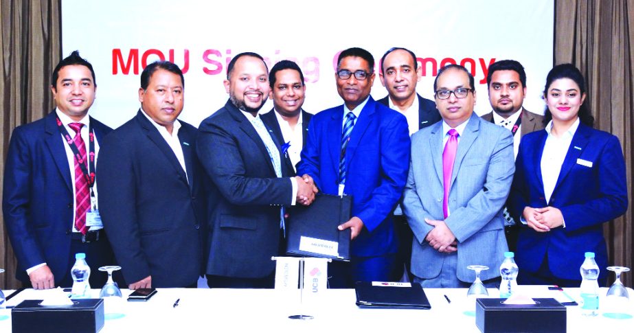Taufiq Hassan, Head of Retail Business of United Commercial Bank Limited and Anwar Hossain, Director (Sales & Marketing) of Le MÃ©ridien Dhaka, exchanging a MoU signing documents at a local hotel in the city recently. Under the deal, Platinum Credit Car