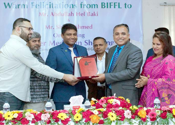Executive Director and Chief Executive Officer (CEO) of Bangladesh Infrastructure Finance Fund Limited (BIFFL) handing over the crest of honour to shooter Abdullah Hel Baki at the office room in BIFFL recently. BIFFL gave crests and cheques to shooters Ab