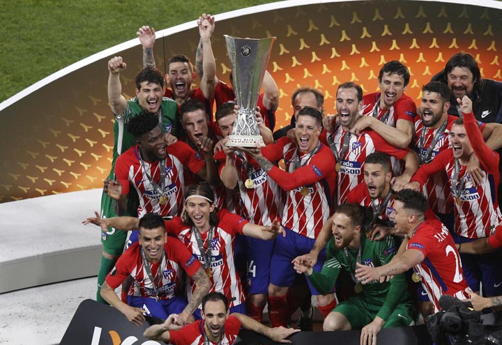 Atletico Madrid players celebrate with the cup after the Europa League Final soccer match between Marseille and Atletico Madrid at the Stade de Lyon outside Lyon, France on Wednesday. Atletico Madrid won the Europa League for the third time with a resound