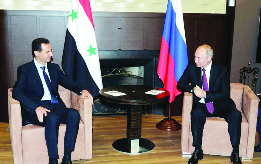 Russian President Vladimir Putin Â® speaks with his Syrian counterpart Bashar al-Assad during their meeting in Sochi.
