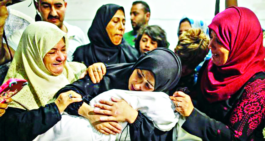 The mother of Layla Ghandour, a Palestinian baby of eight months who died during Monday's violence in Gaza, holds her at the morgue of al-Shifa hospital in Gaza City.