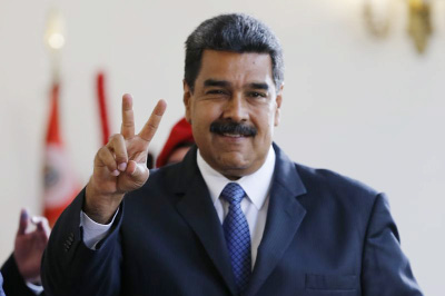 Venezuela's President Nicolas Maduro makes the victory sign after a meeting with former Spanish Prime Minister Jose Luis Rodriguez Zapatero (not seen) at the presidential palace in Caracas, Venezuela on Friday.
