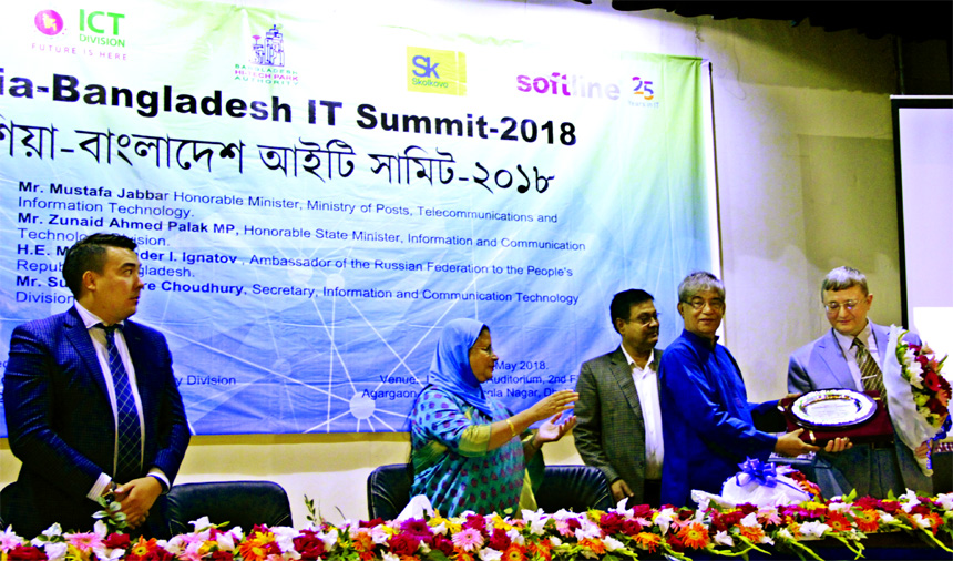 ICT Minister Mostafa Jabbar, handing over a crest of honour to Sergey Popov, Minister-Counselor of the Russian Embassy at the inaugural ceremony of Russia-Bangladesh IT Summit-2018 at ICT Tower in the city on Sunday. Hosneara Begum, Managing Director of