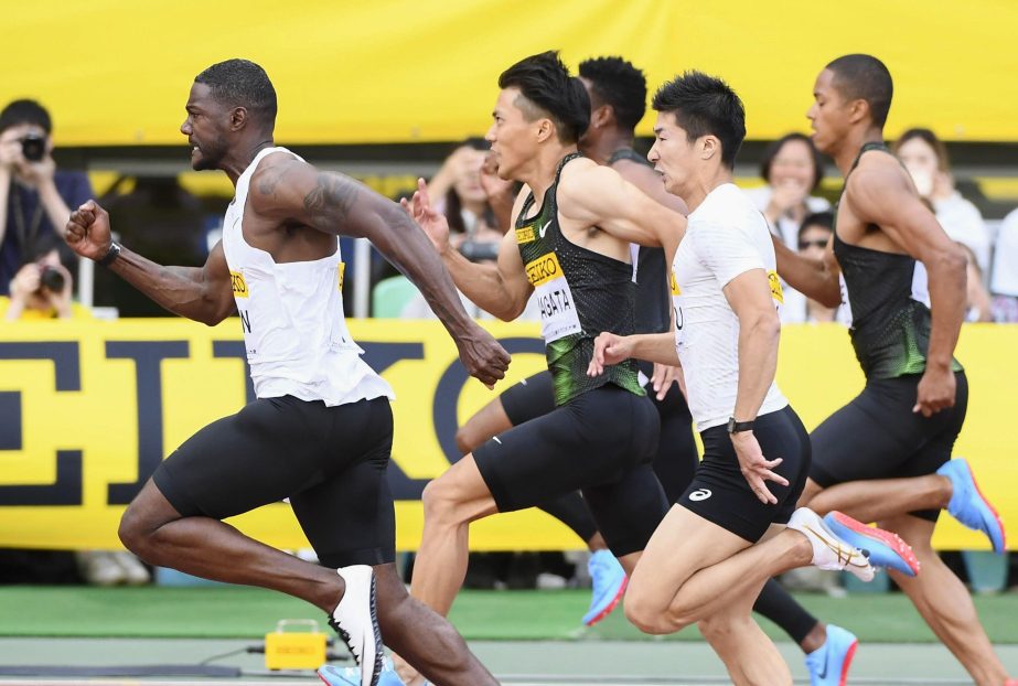 Justin Gatlin (left) of the United States competes on his way to winning the men's 100 meters at the Golden Grand Prix track and field event in Osaka, western Japan on Sunday. Gatlin clocked 10.06 seconds to win the 100 meters, ahead of Japan's Ryota Ya