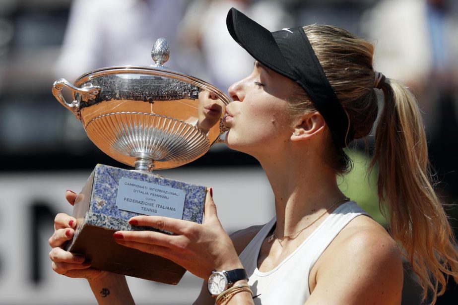 Ukraine's Elina Svitolina kisses the trophy after winning her final match against Simona Halep at the Italian Open tennis tournament, in Rome on Sunday. Svitolina won 6-0, 6-4.