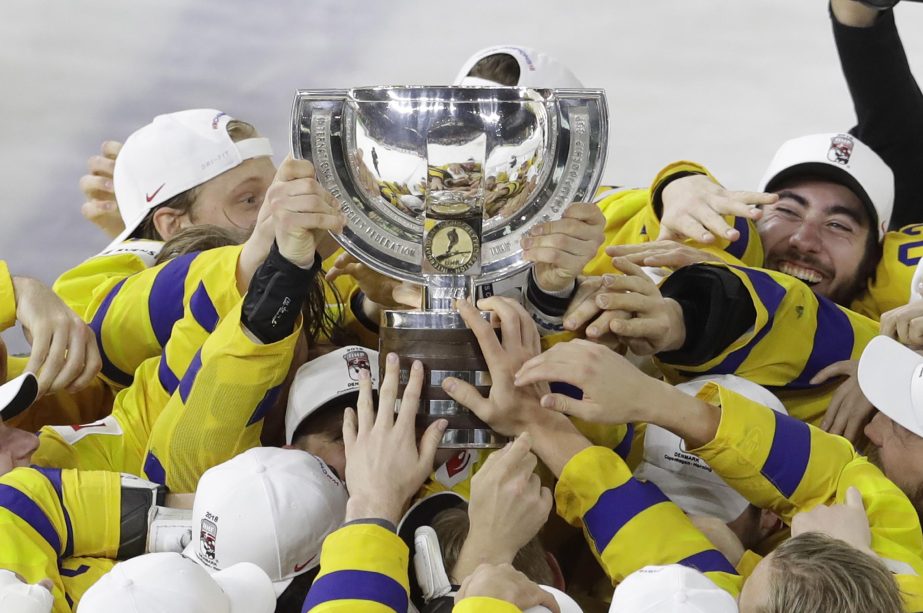 Sweden's players celebrate with the trophy their victory over Switzerland in the Ice Hockey World Championships final match between Sweden and Switzerland at the Royal arena in Copenhagen, Denmark on Sunday.