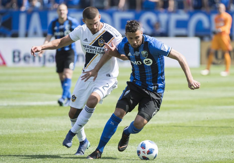 Montreal Impact's Saphir Taider (right) challenges L.A. Galaxy's Perry Kitchen during first-half MLS soccer game action in Montreal on Monday.