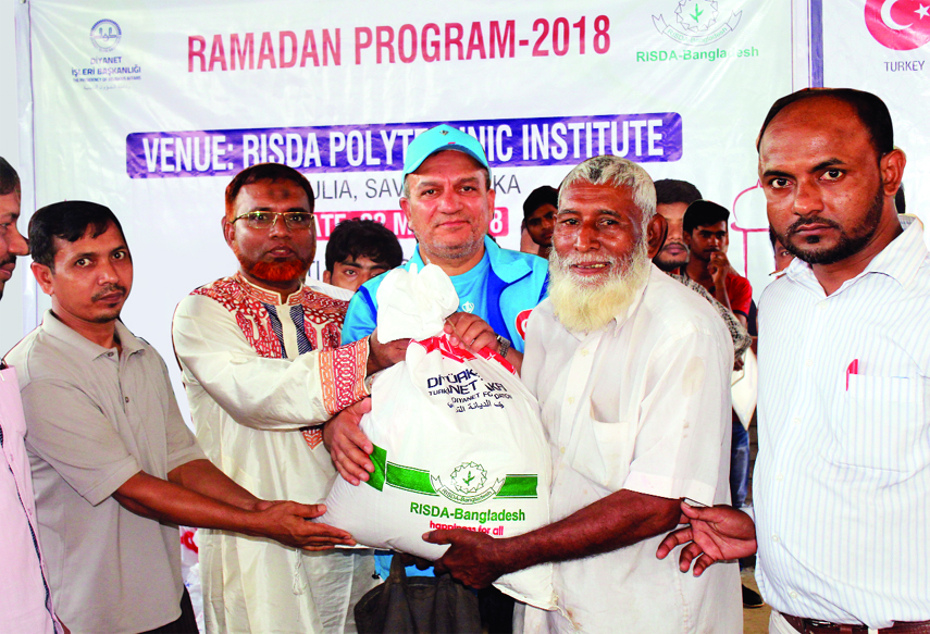SAVAR: Risda-Bangladesh, an NGO distributing iftar items among the distressed people at Risda Polytechnic Institute's campus on Monday. Dr Md Hemayet Hossain, Executive Director, Risda- Bangladesh was present in the programme.