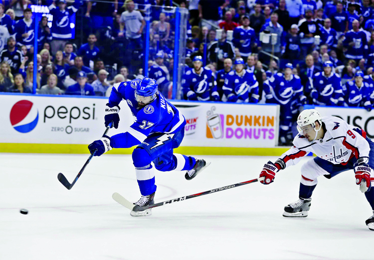 Tampa Bay Lightning left wing Alex Killorn (left) takes a shot as he gets in front of Washington Capitals defenseman Dmitry Orlov during the second period of Game 7 of the NHL Eastern Conference finals hockey playoff series on Wednesday.