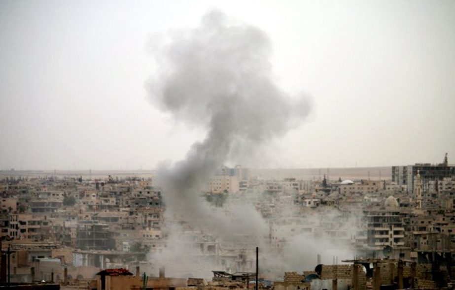 Smoke rises from buildings in a rebel-held neighbourhood of Daraa in southern Syria following reported shelling by the regime.