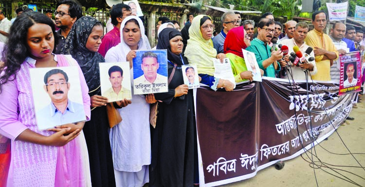 Members of enforced disappearance families formed a human chain in front of the Jatiya Press Club on Saturday marking International Day of Enforced Disappearance.