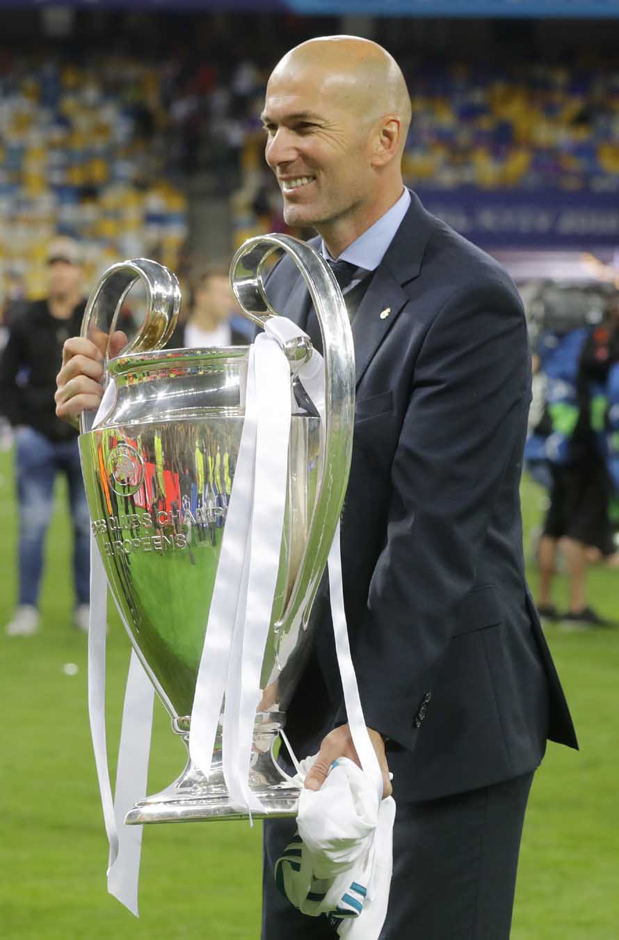 Real Madrid coach Zinedine Zidane holds the trophy after winning the Champions League Final soccer match between Real Madrid and Liverpool at the Olimpiyskiy Stadium in Kiev, Ukraine on Saturday.