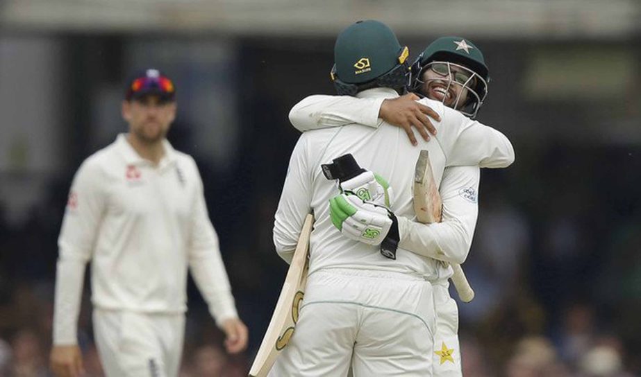 Pakistanâ€™s Haris Sohail (left) and teammate Ima-ul-Haq hug as they celebrate after defeating England by 9 wickets on the fourth day of play of the first test cricket match between England and Pakistan at Lordâ€™s cricket ground in London on S