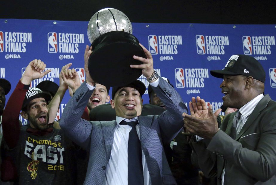 Cleveland Cavaliers head coach Tyronn Lue hoists the trophy after beating the Boston Celtics 87-79 in Game 7 of the NBA basketball Eastern Conference finals in Boston on Sunday.