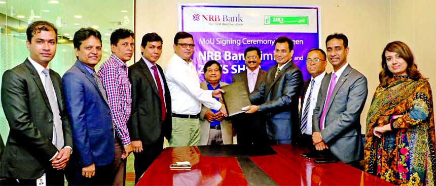 Imran Ahmed, Chief Operating Officer of NRB Bank Limited and Jashim Md Al Amin, Managing Director of Zeil's Shop Limited, exchanging an agreement signing documents at the banks head office in the city on Sunday. Under the deal, Debit and Credit Cardholde