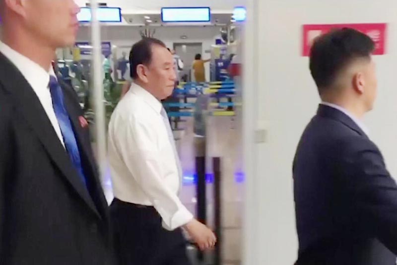 Kim Yong Chol, center , a former military intelligence chief who is now Kim Jong Un's top official on inter-Korean relations, walks upon arrival at Beijing airport in Beijing on Tuesday.