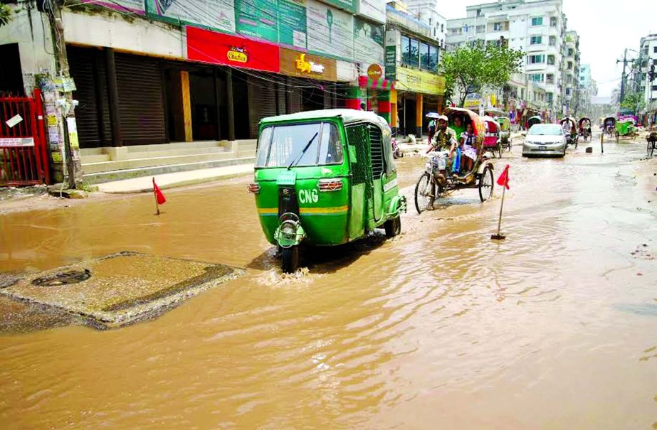 Big potholes being developed as rain water submerges the main thoroughfare at South Banasree in Khilgaon. This photo was taken on Tuesday.