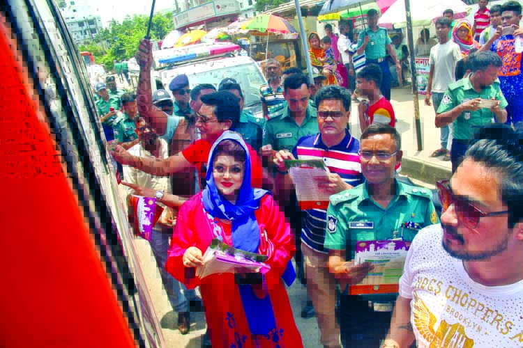Deputy Police Commissioner of Dhaka North Traffic Division Probir Kumar, among others, distributing leaflets with a view to avoiding road accident on the occasion of holy Ramzan. The snap was taken from the city's Kakoli area on Wednesday.