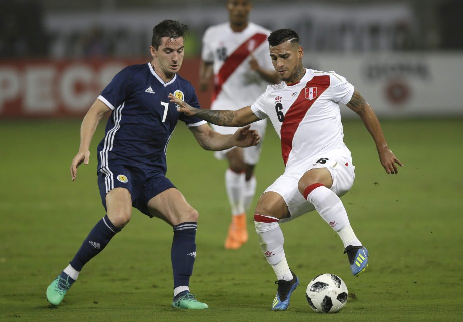 Peru's Miguel Trauco (right) fights for the ball with Scotland's Kenny McLean during a friendly soccer match in Lima, Peru on Tuesday.