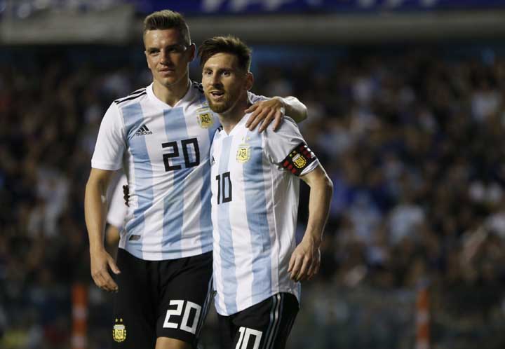Argentina's Giovanni Lo Celso (left) congratulates teammate Lionel Messi after he scored during a friendly soccer match between Argentina and Haiti at the Bombonera stadium in Buenos Aires, Argentina on Tuesday.