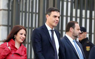 Spain's Socialist (PSOE) leader Pedro Sanchez walks with fellow party members Jose Luis Abalos and Adriana Lastras as he arrives at Parliament to attend the final day of a motion of no confidence debate in Madrid on Friday.