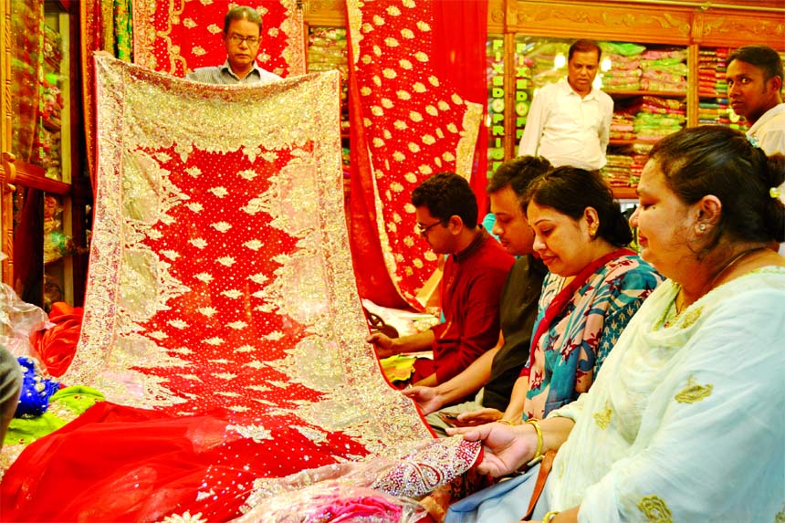 Ahead of Eid-ul-Fitr, customers are making their choice at a saree shop in city's New market on Friday.