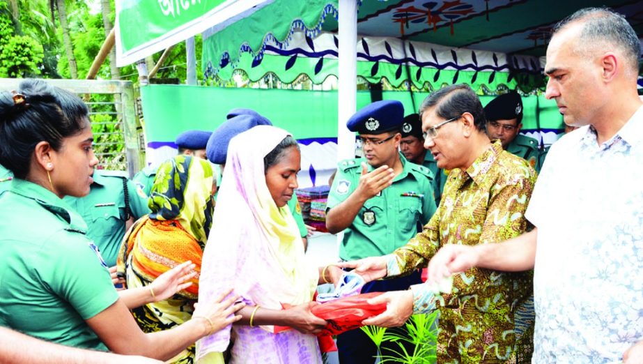 DMP Commissioner Asaduzzaman Mia distributing Eid clothes among destitute in front of the Engineers Institution in the city on Saturday.