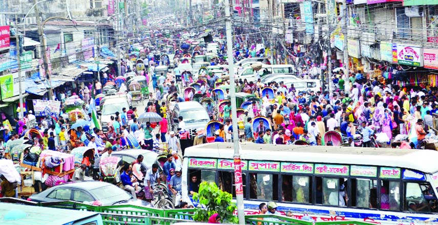 Haphazard illegal parking and unauthorized vendor shops on roadsides and footpaths are forcing city traffic to come to a grinding halt. Eid shoppers are crowding in city malls and super markets making the city immovable. This photo has been taken from N