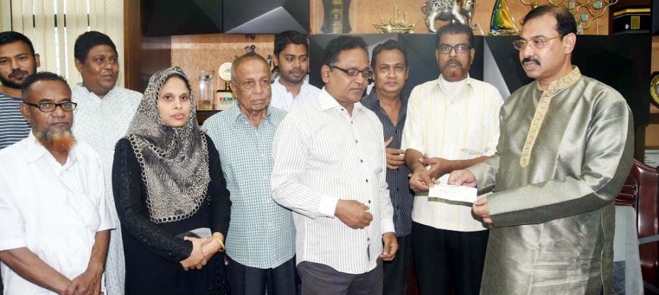 CCC Mayor A J M Nasir Uddin donating cheque of Tk 2 lakh for treatment of Abdul Malek at his office on Saturday.